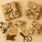 Designer’s Shop WR 63-5215 2.5" x 10 Yards Christmas Wreath Wired Edge Ribbon – Gold Glitter Pinecones, Red Poinsettias & Holiday Garland